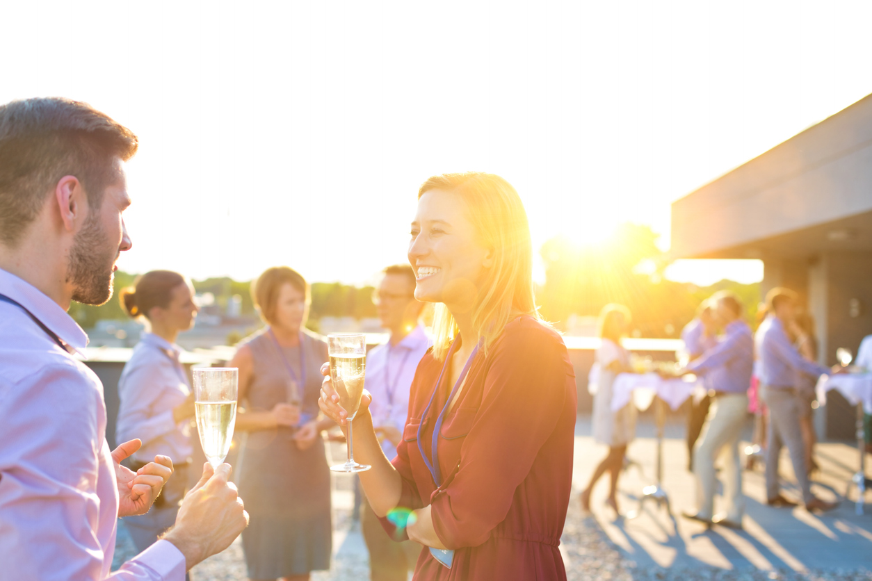 Party guests mingling at a mystery party game.